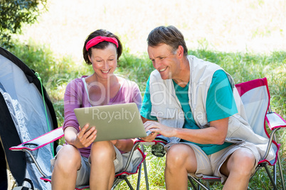 senior couple looking their laptop