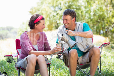 senior couple serving a cup of coffee