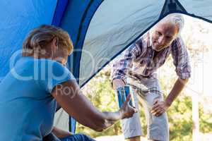 Senior couple relaxing inside their tent