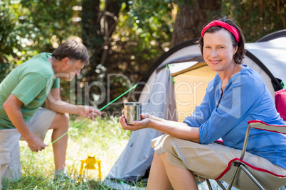 Senior couple relaxing beside their tent