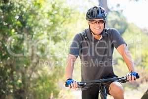 Man smiling and posing with his bike