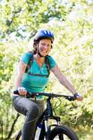 Mature woman smiling and riding bike
