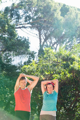 Couple stretching their arms