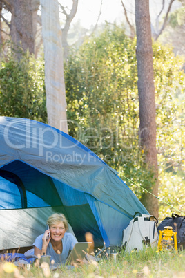 Mature woman laying and calling on the phone