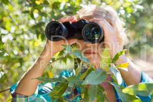 Close up of a woman looking on binoculars