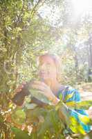 Mature woman smiling and holding binoculars