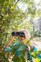 Mature woman looking on binoculars