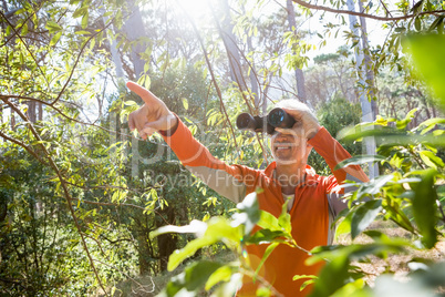 Mature man looking on binoculars