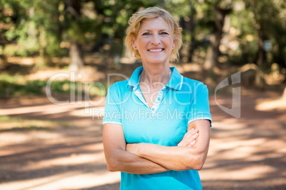 Mature woman smiling and posing with arms crossed