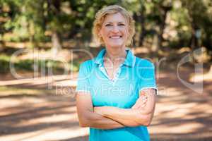 Mature woman smiling and posing with arms crossed