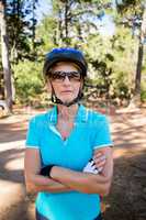 Mature bike rider woman posing with arms crossed