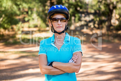 Mature bike rider woman posing with arms crossed