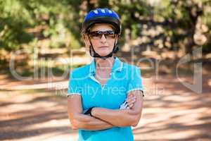 Mature bike rider woman posing with arms crossed