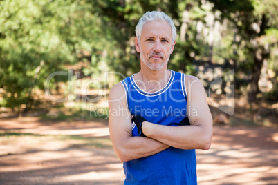 Mature man posing with arms crossed