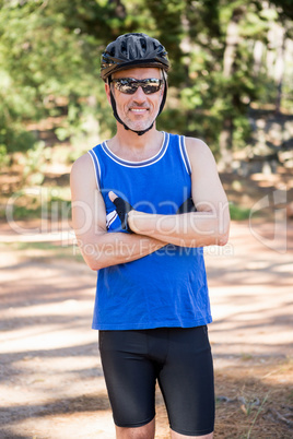 Mature bike rider man posing with arms crossed