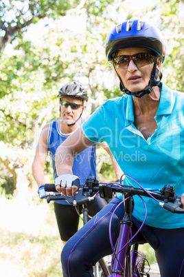 Mature couple with sunglasses riding bike