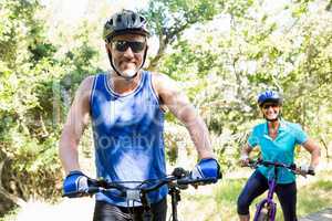 Mature couple with sunglasses riding bike