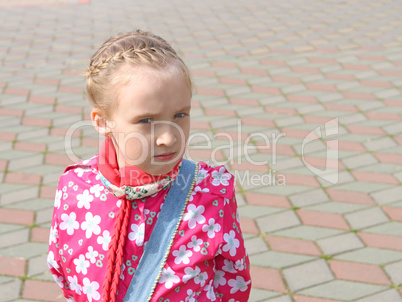 Portrait of small pensive schoolgirl