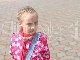 Portrait of small pensive schoolgirl