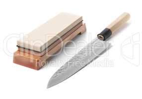 Trditional japanese kitchen knife and water stone. Isolated on w