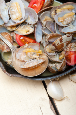 fresh clams on an iron skillet