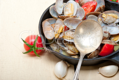 fresh clams on an iron skillet