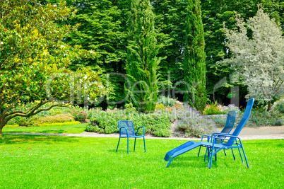 beautiful summer park with lawn and recliner