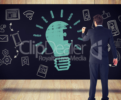 Composite image of businessman standing back to camera writing w