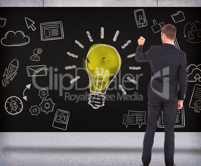 Composite image of business man writing with chalk