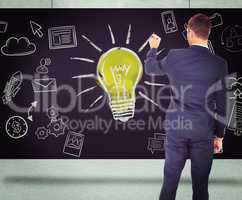 Composite image of business man writing with chalk