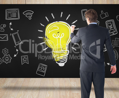 Composite image of businessman standing back to camera writing w