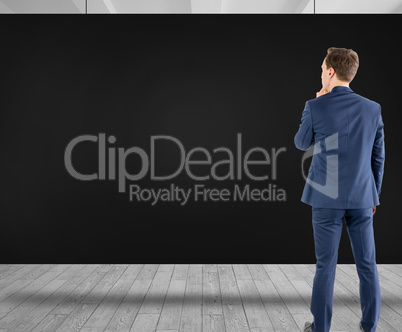 Composite image of wear view of businessman thinking