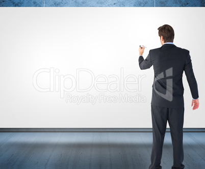 Composite image of businessman standing back to camera writing w