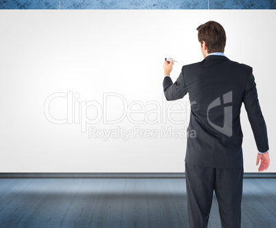 Composite image of businessman standing back to camera writing w