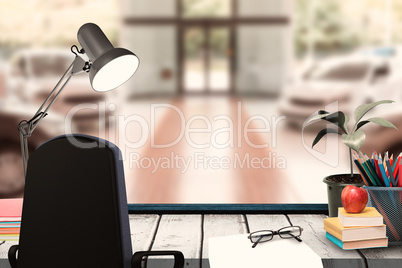 Composite image of a desk with lamp and documents