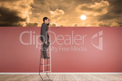 Composite image of happy businessman standing on ladder