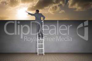 Composite image of businessman standing on ladder