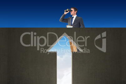 Composite image of businessman looking on a ladder