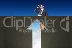 Composite image of businessman looking on a ladder