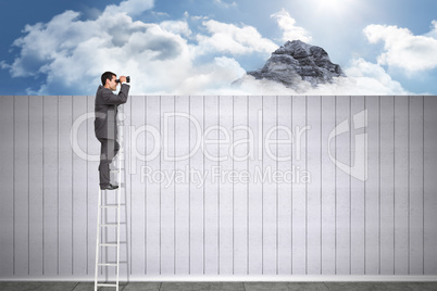 Composite image of businessman standing on ladder using binocula