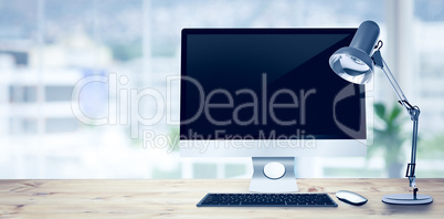 Composite image of image of a desk with computer