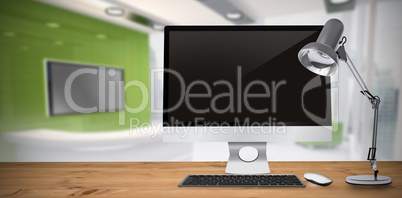 Composite image of image of a desk with computer