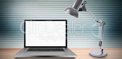 Composite image of desk with laptop