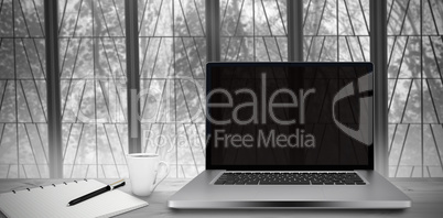 Composite image of desk with laptop