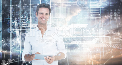 Composite image of portrait of smiling man using digital tablet