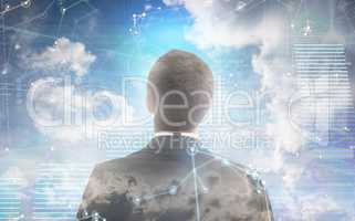 Composite image of businessman looking up in suit