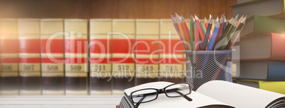 Composite image of school supplies on desk Composite image of school supplies on desk