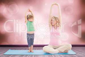 Composite image of pregnant smiling mother and daughter doing yo