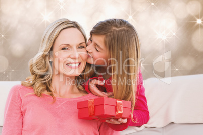 Composite image of smiling mother being kissing by daughter