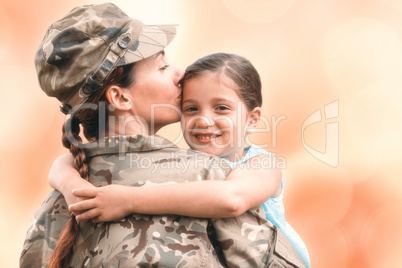 Composite image of close-up of mother in army uniform kissing da